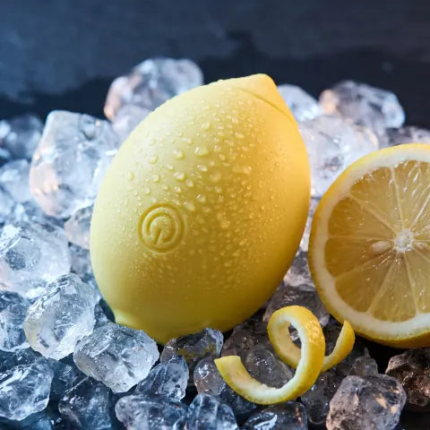 The Limone covered in water droplets on crushed ice beside a halved lemon