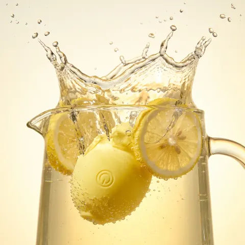 The Limone splashing into a pitcher of lemonade with lemon slices