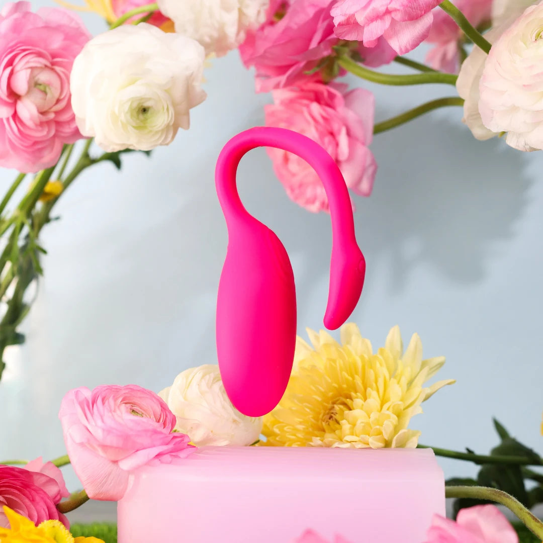 NymMind Flamingo wireless massager styled among fresh flowers